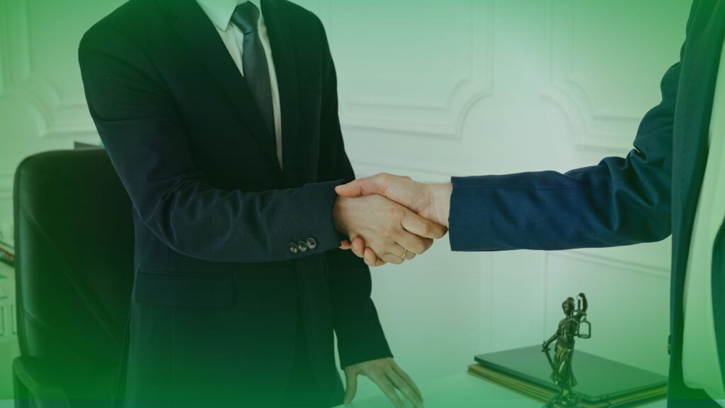 Two professional business partners shaking hands in a bright, modern office, representing the high-trust multi-year contracts typical of the MSP and B2B tech sector.